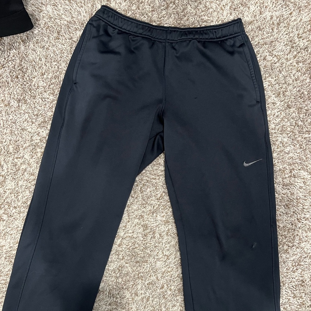 Men’s Nike sweatpants with worn place on leg